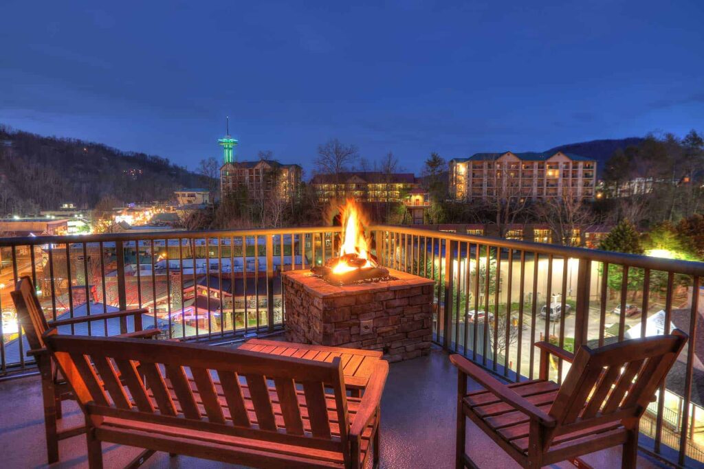 family-friendly hotels in the Great Smoky Mountains, Black Bear Inn & Suites beautiful balcony view with gas fireplace and rustic camp chairs