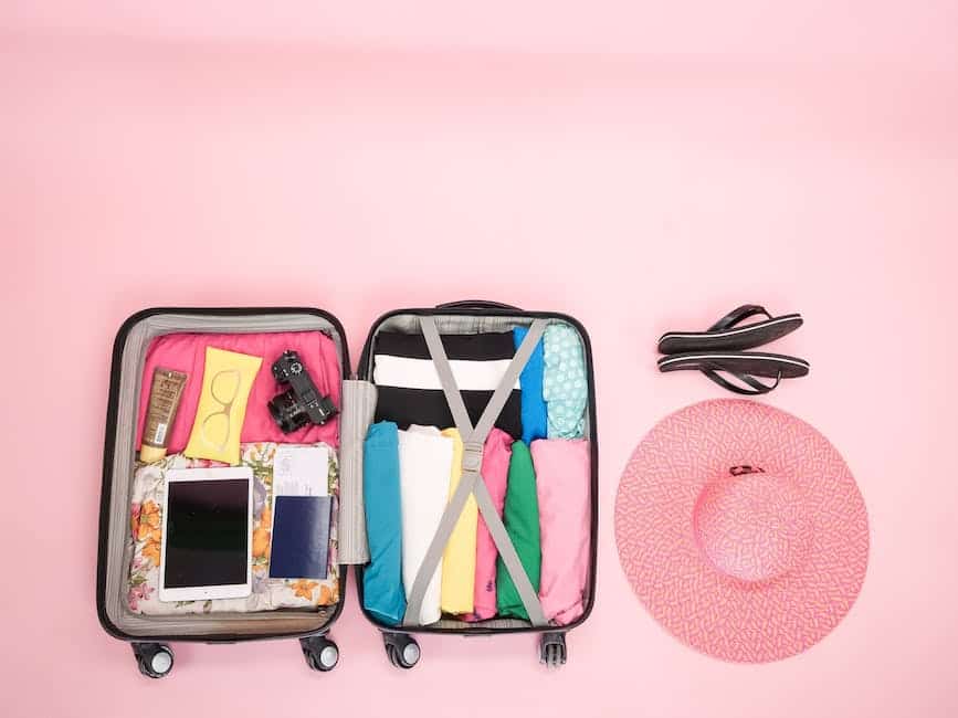 A photo displaying a neatly packed suitcase with clothes and accessories organized using packing cubes, rolled clothes, and layering techniques.