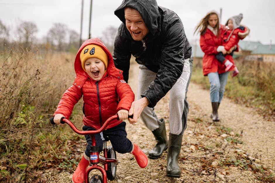 Kid's travel journal - a father playing with his son on a bike while the mother walks behind with the baby.