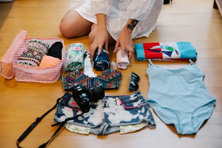 A parent carefully packing their child's luggage for a stress-free family travel trip by laying everything out on the floor